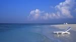 A Deck Chair in the Water on a Maldives Beach 16:9